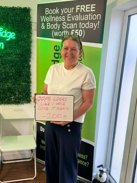 A Bamber Bridge Nutrition club member with her assessment board