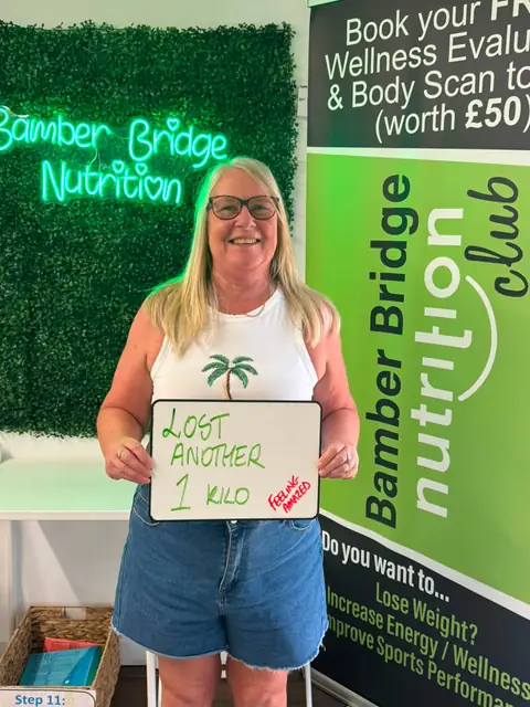 A Bamber Bridge Nutrition club member with her assessment board