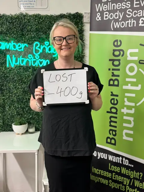 A Bamber Bridge Nutrition club member with her assessment board