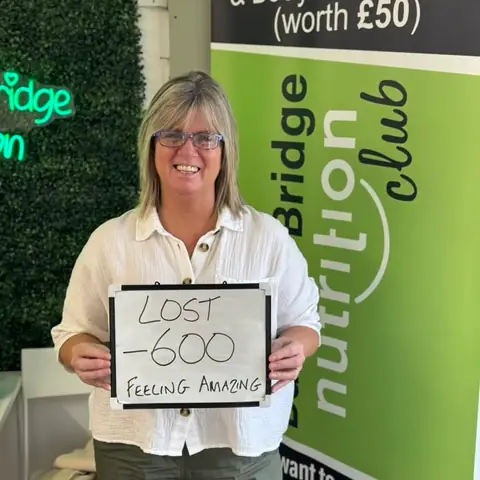At the Bamber Bridge club, a member holding up the board with her results